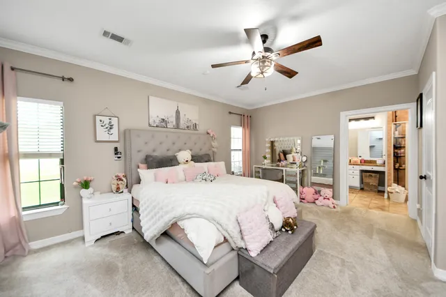 a bedroom with a bed a dresser and flat screen tv