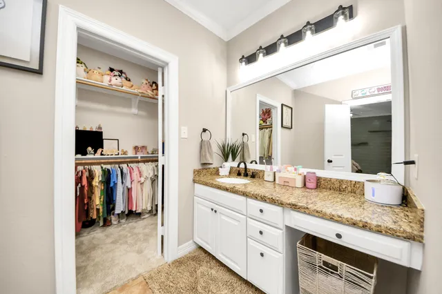 a bath tub sitting next to a bathroom sink and a large mirror