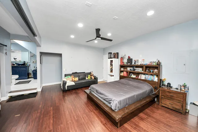 a room with stainless steel appliances kitchen island granite countertop a sink and cabinets