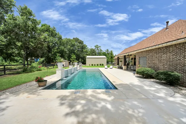 a view of a swimming pool with sitting area