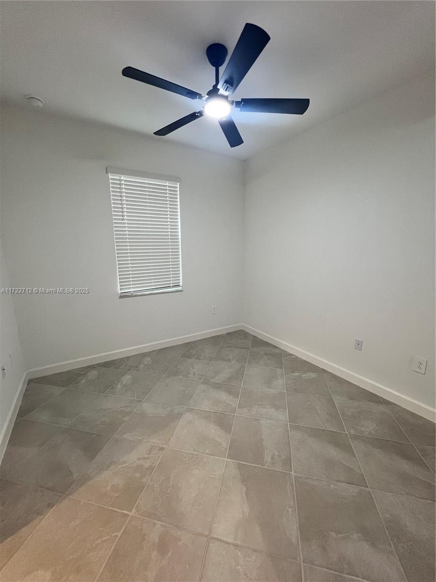 17417 Muscat Lane Punta Gorda, FL 33955 - Photo 11 of 13 an empty room with a ceiling fan and window