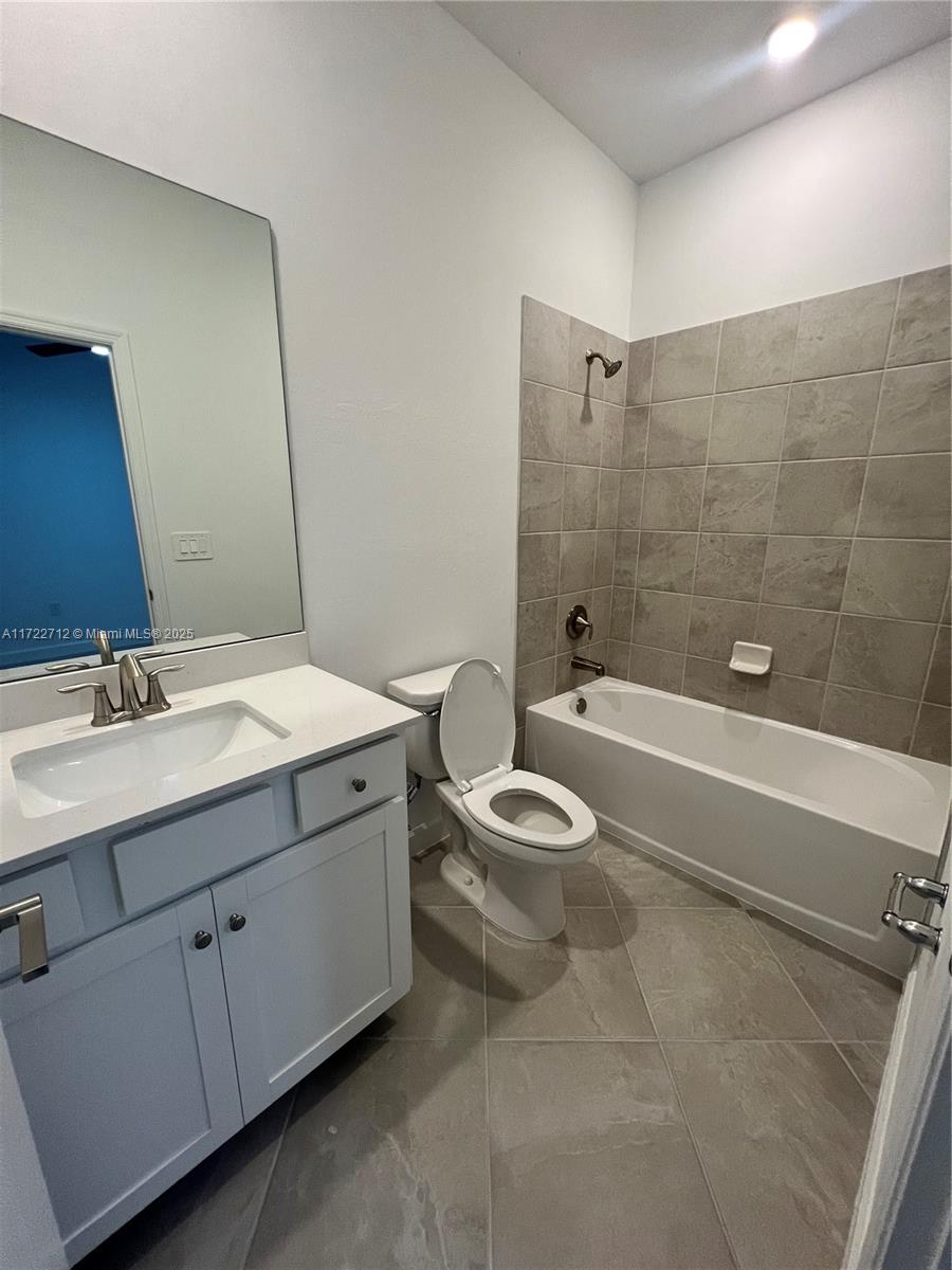 17417 Muscat Lane Punta Gorda, FL 33955 - Photo 12 of 13 a bathroom with a granite countertop toilet a sink and bathtub