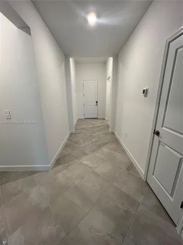 a large kitchen with kitchen island a sink stainless steel appliances and cabinets