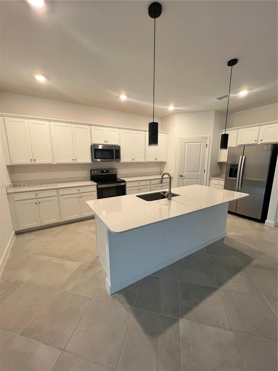 17417 Muscat Lane Punta Gorda, FL 33955 - Photo 4 of 13 a large kitchen with kitchen island a sink stainless steel appliances and cabinets