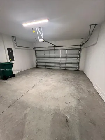an empty room with a ceiling fan and window