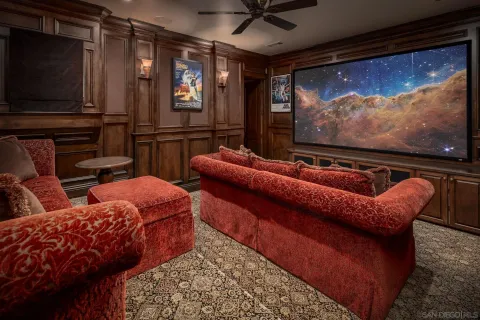 a room with pool table flat screen tv and window