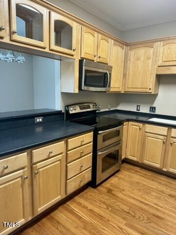 7530 Lead Mine Road, Unit 306 Raleigh, NC 27615 - Photo 4 of 29 a kitchen with stainless steel appliances granite countertop a stove a sink and white cabinets