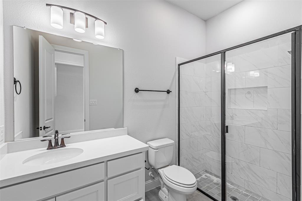 6753 Verandah Way Irving, TX 75039 - Photo 19 of 40 a bathroom with a sink a toilet and shower