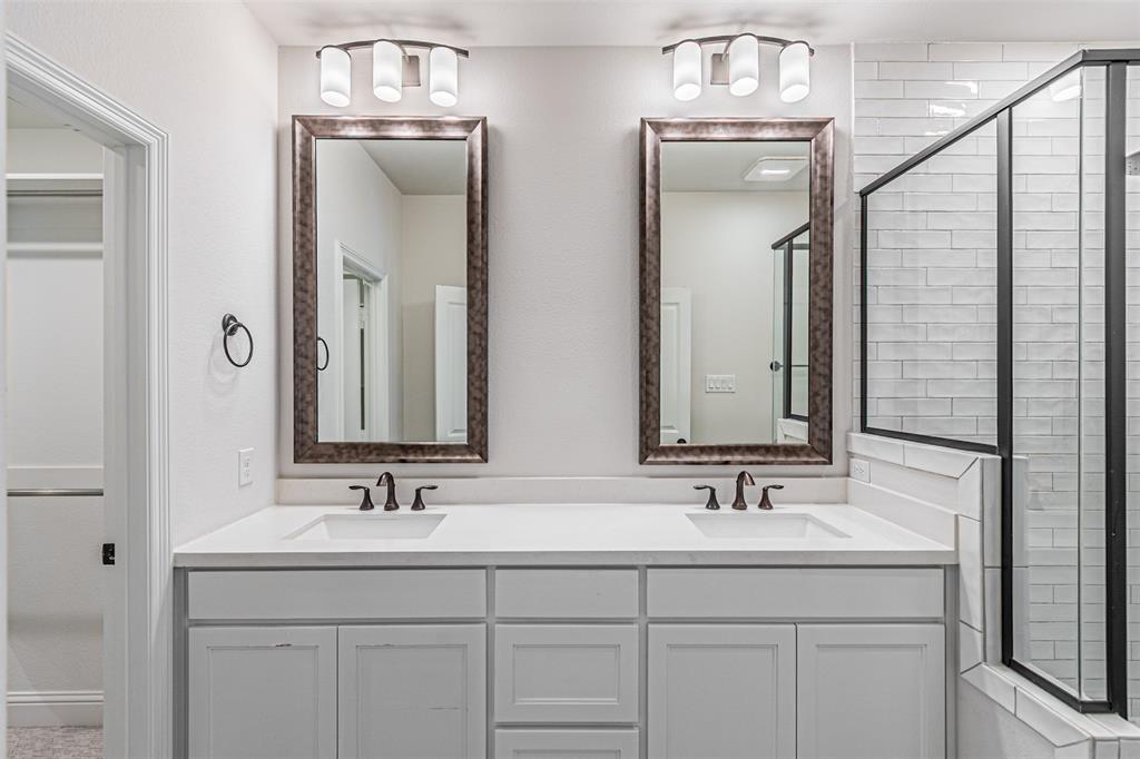 6753 Verandah Way Irving, TX 75039 - Photo 35 of 40 a bathroom with double sink and a mirror