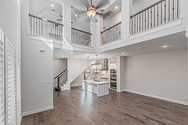 a view of a hallway with entryway and wooden floor