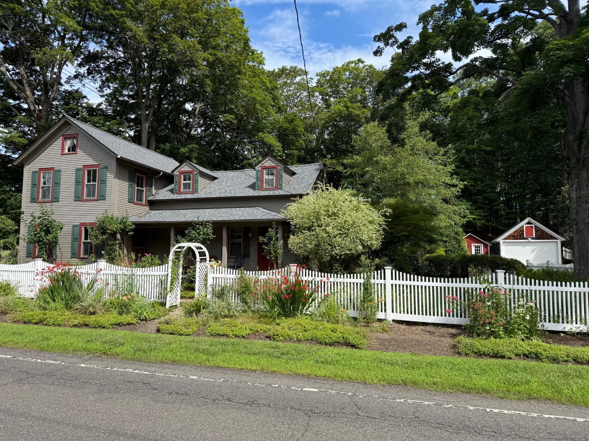 a front view of a house with a garden