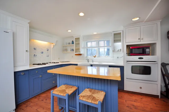 a kitchen with stainless steel appliances granite countertop a sink counter space and wooden floor