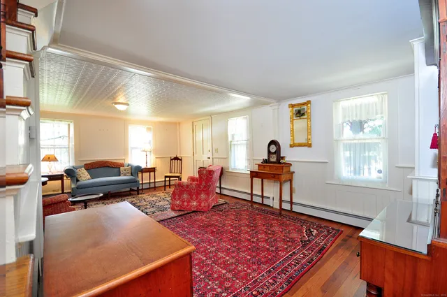 a bedroom with furniture and wooden floor