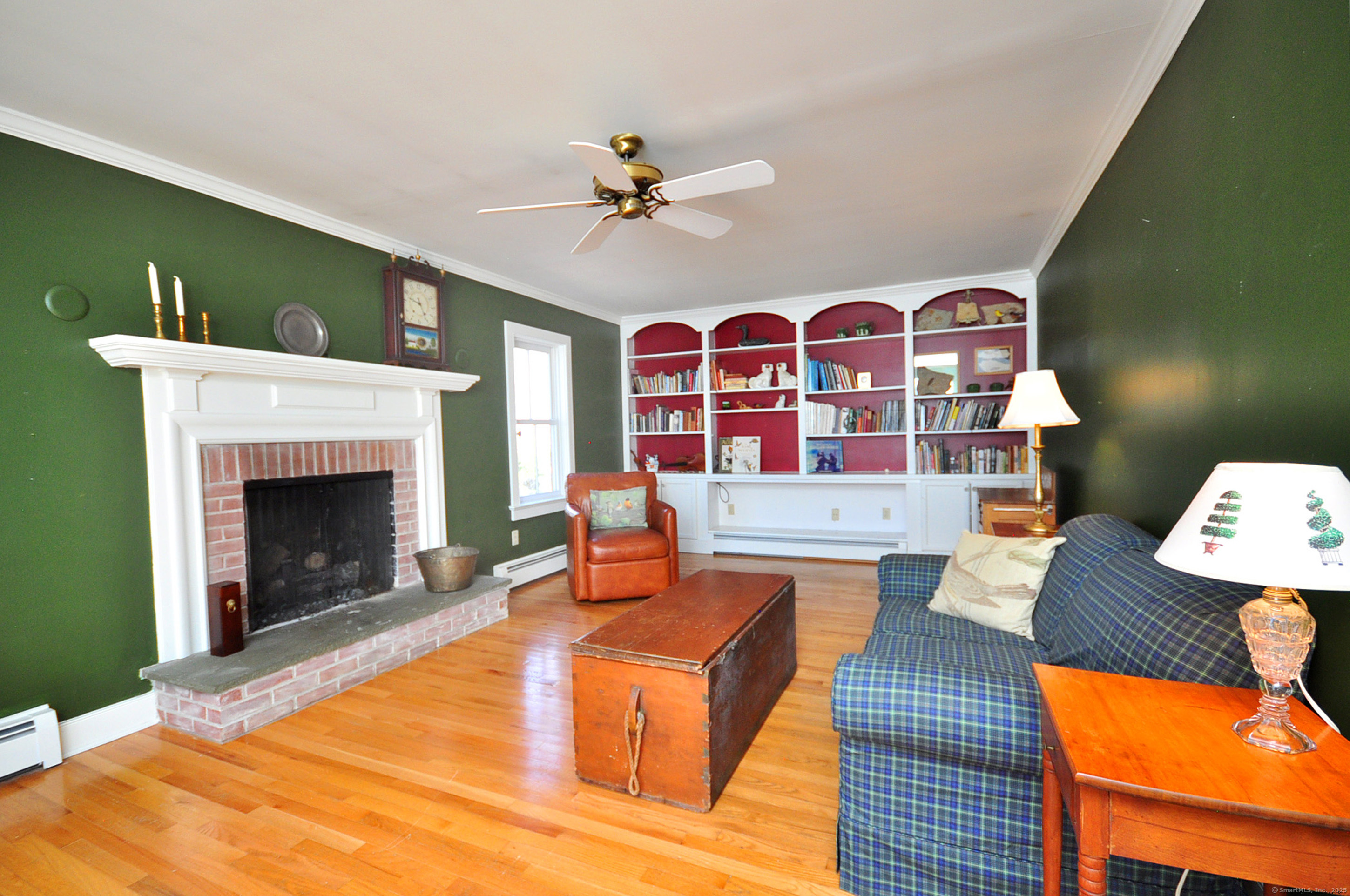 72 Clapboard Road Bridgewater, CT 06752 - Photo 27 of 39 a living room with furniture fireplace and wooden floor