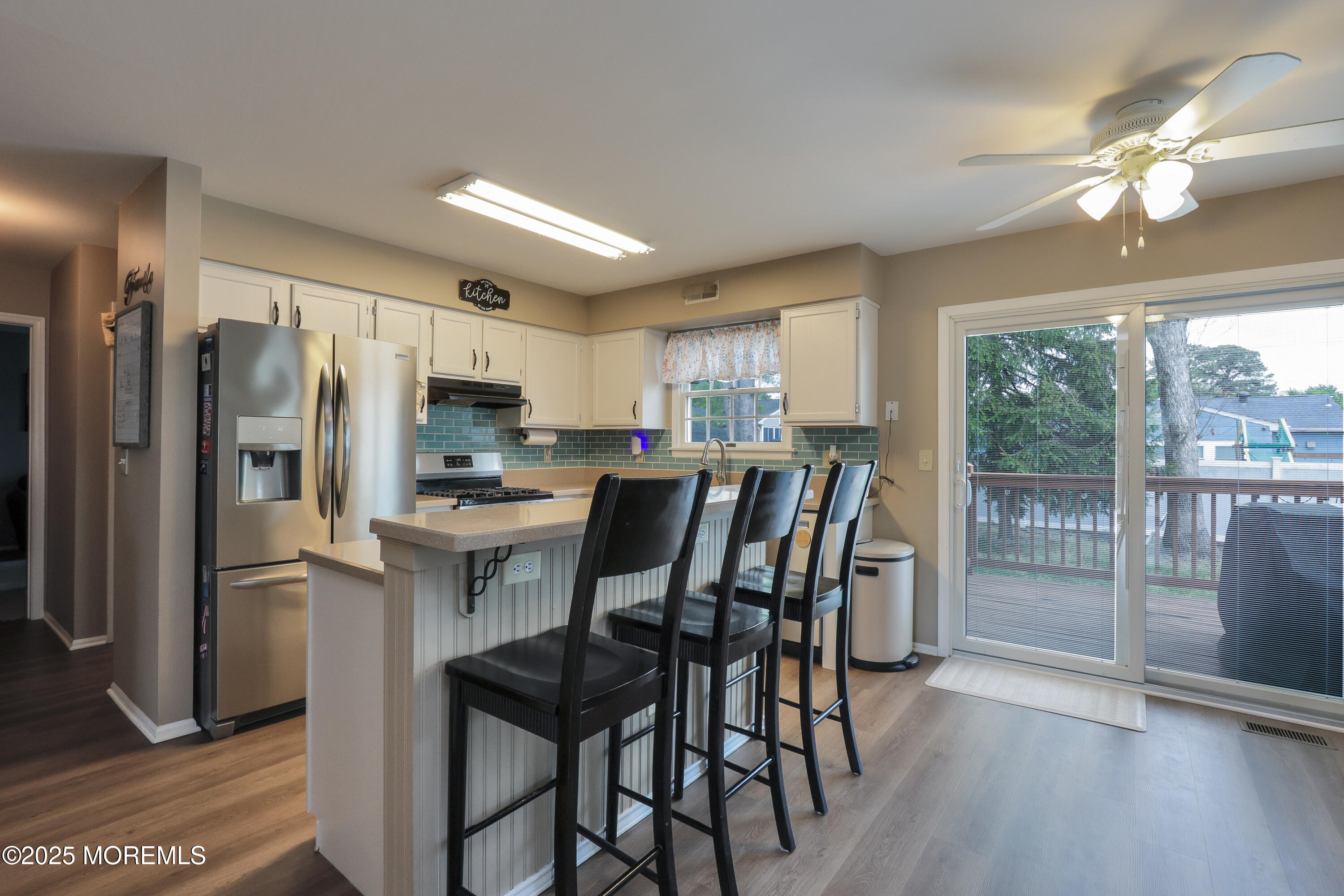 204 Stormy Road Manahawkin, NJ 08050 - Photo 13 of 44 a kitchen with kitchen island wooden cabinets and stainless steel appliances