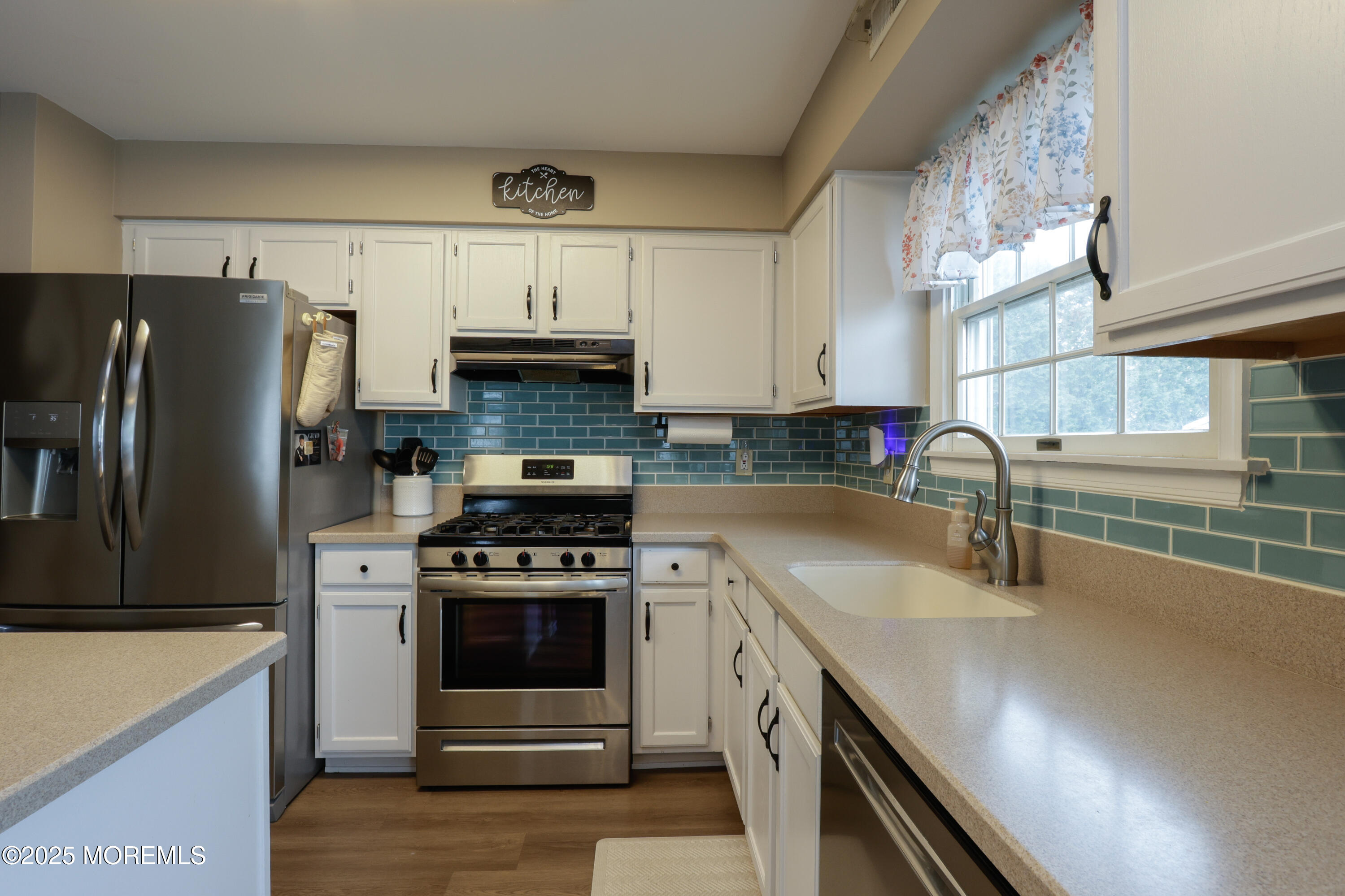 204 Stormy Road Manahawkin, NJ 08050 - Photo 15 of 44 a kitchen with granite countertop a sink stove and refrigerator