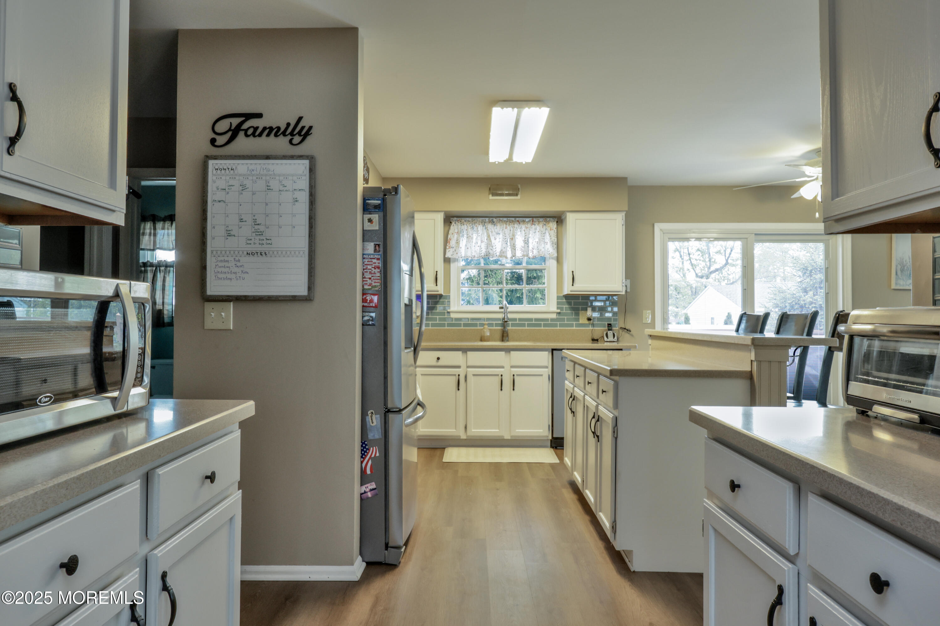 204 Stormy Road Manahawkin, NJ 08050 - Photo 18 of 44 a kitchen with a sink stove and cabinets