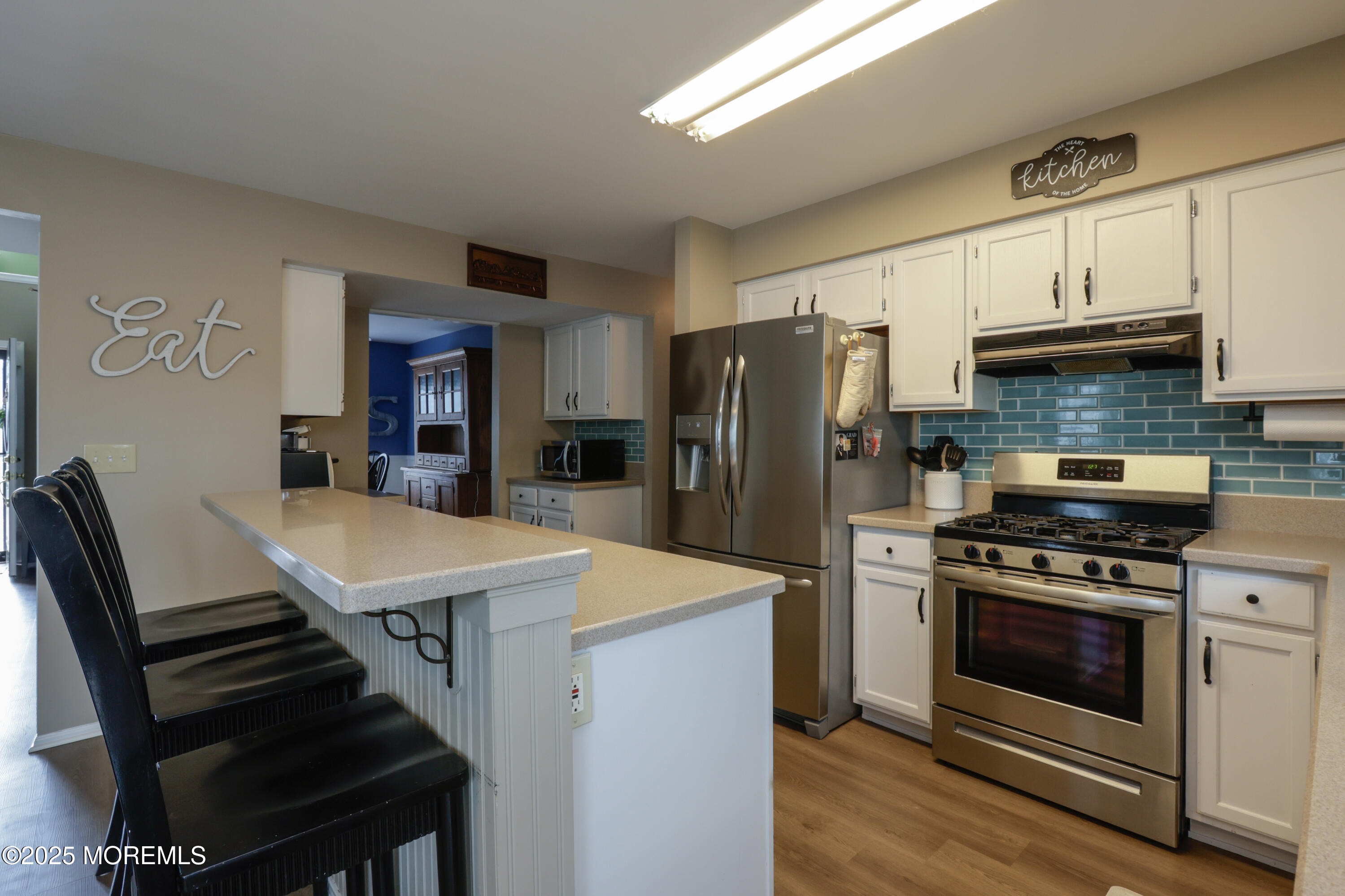 204 Stormy Road Manahawkin, NJ 08050 - Photo 19 of 44 a kitchen with a stove a refrigerator and a stove top oven