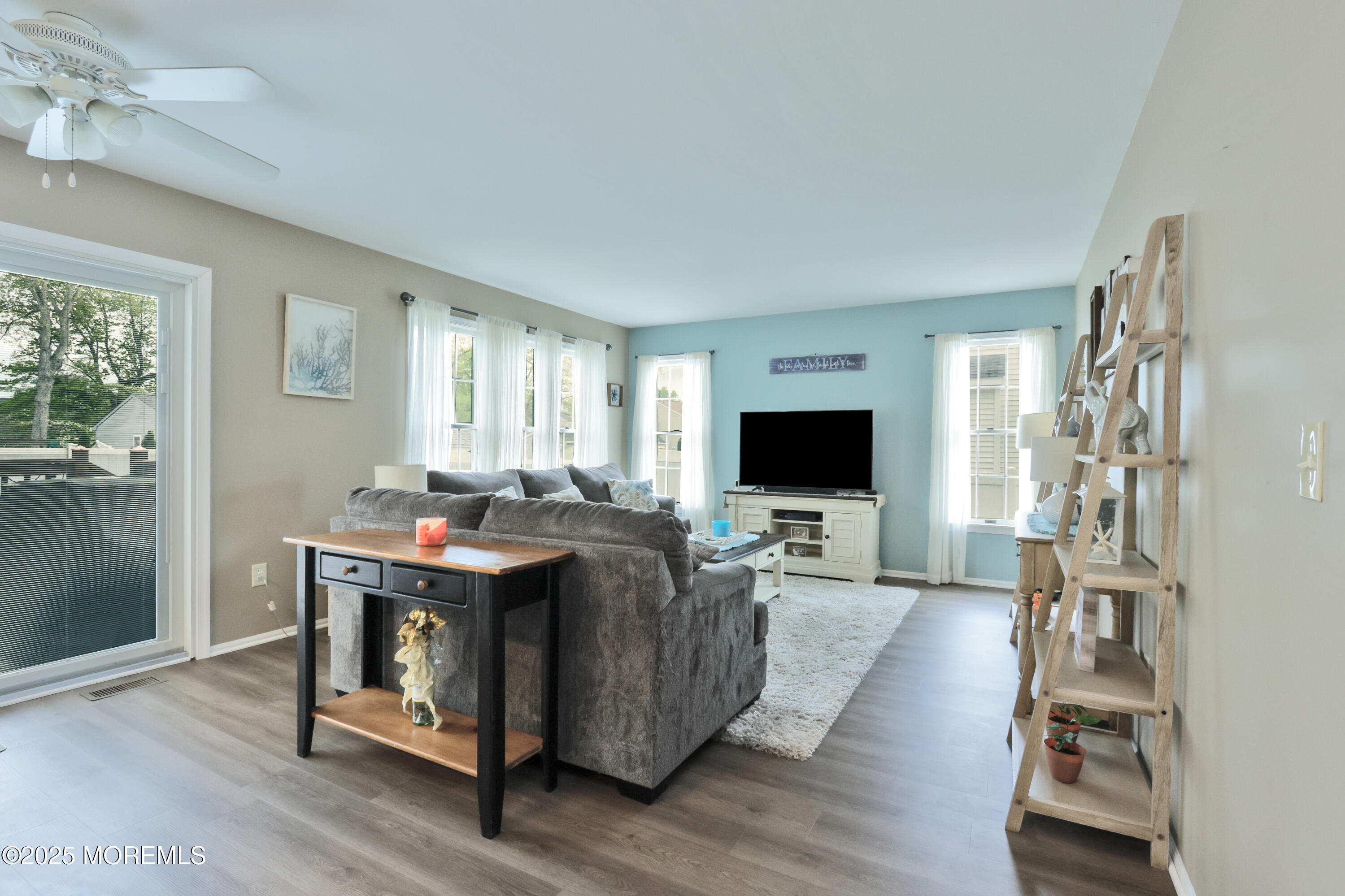 204 Stormy Road Manahawkin, NJ 08050 - Photo 25 of 44 a living room with furniture a flat screen tv and a fireplace