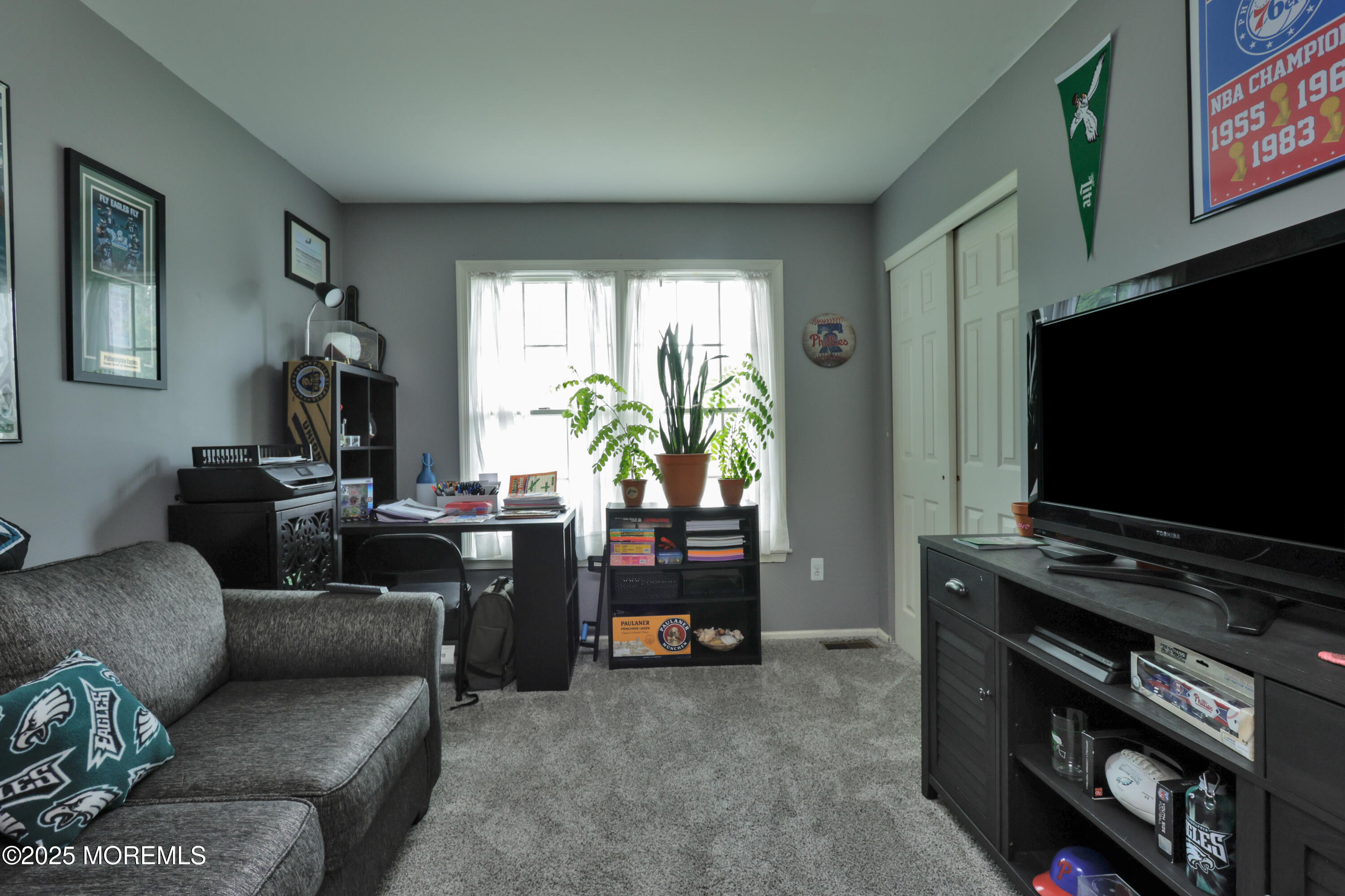 204 Stormy Road Manahawkin, NJ 08050 - Photo 29 of 44 a living room with furniture and a flat screen tv
