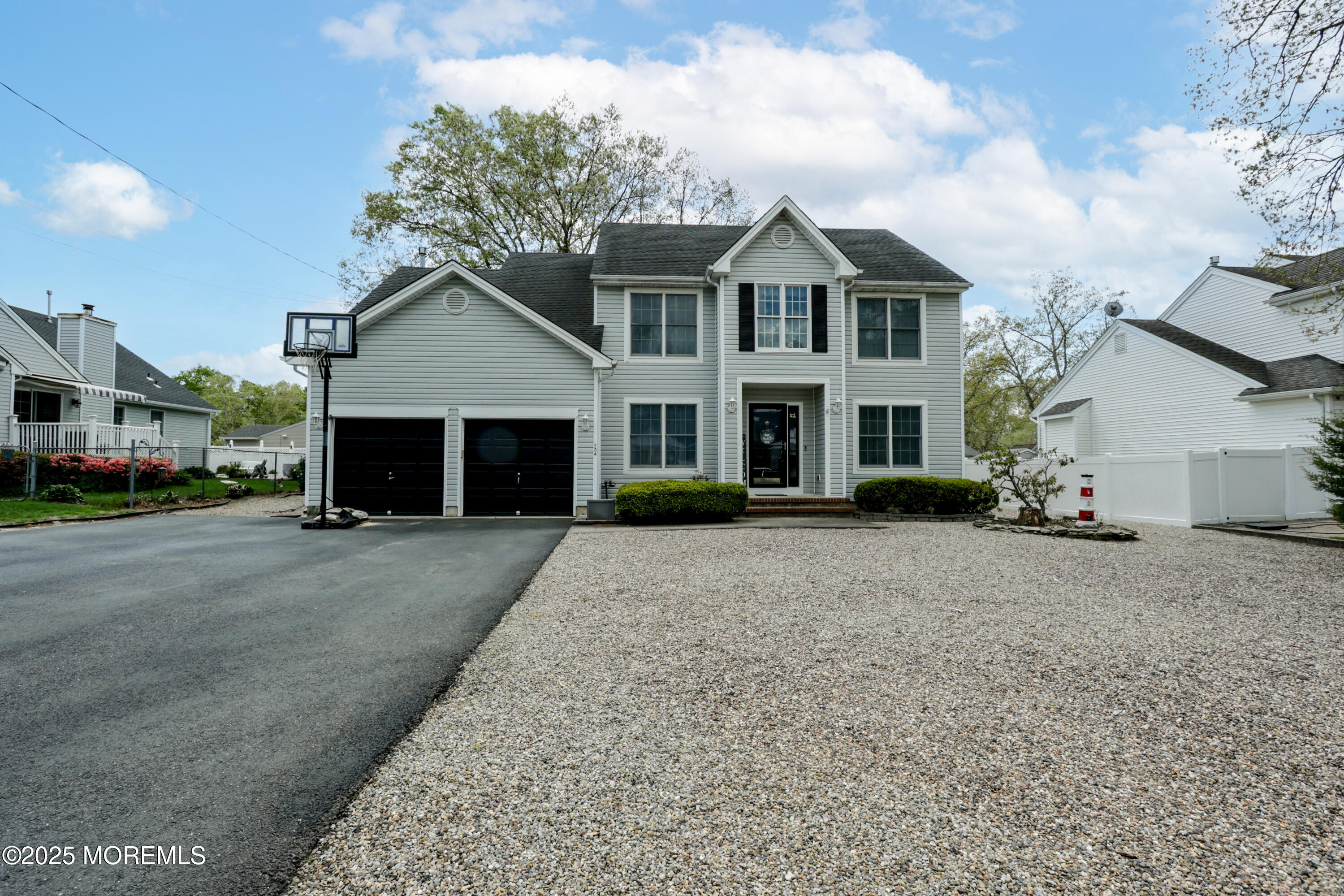 204 Stormy Road Manahawkin, NJ 08050 - Photo 3 of 44 a front view of a house with a yard and garage