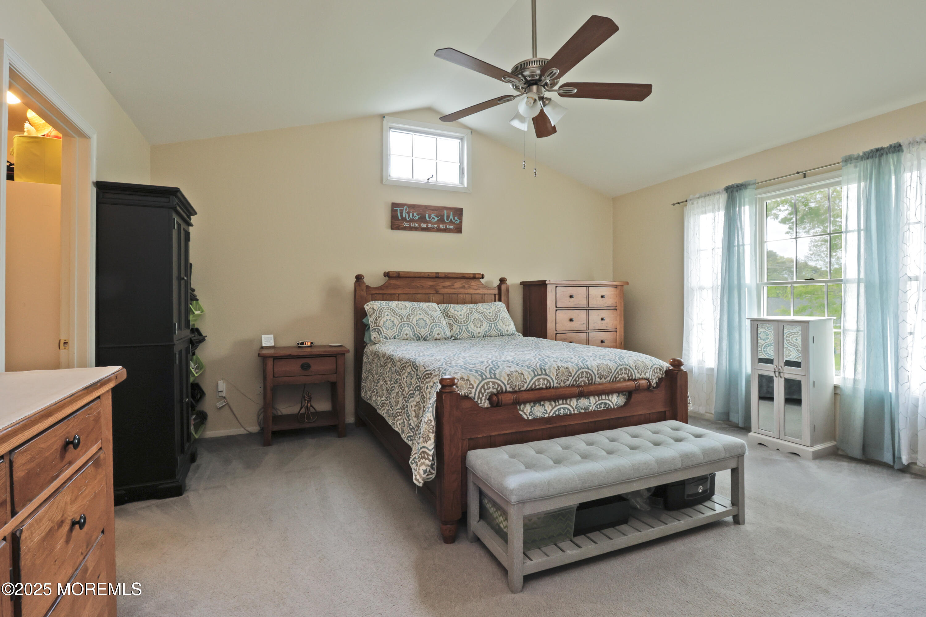 204 Stormy Road Manahawkin, NJ 08050 - Photo 33 of 44 a bedroom with a bed and a chandelier
