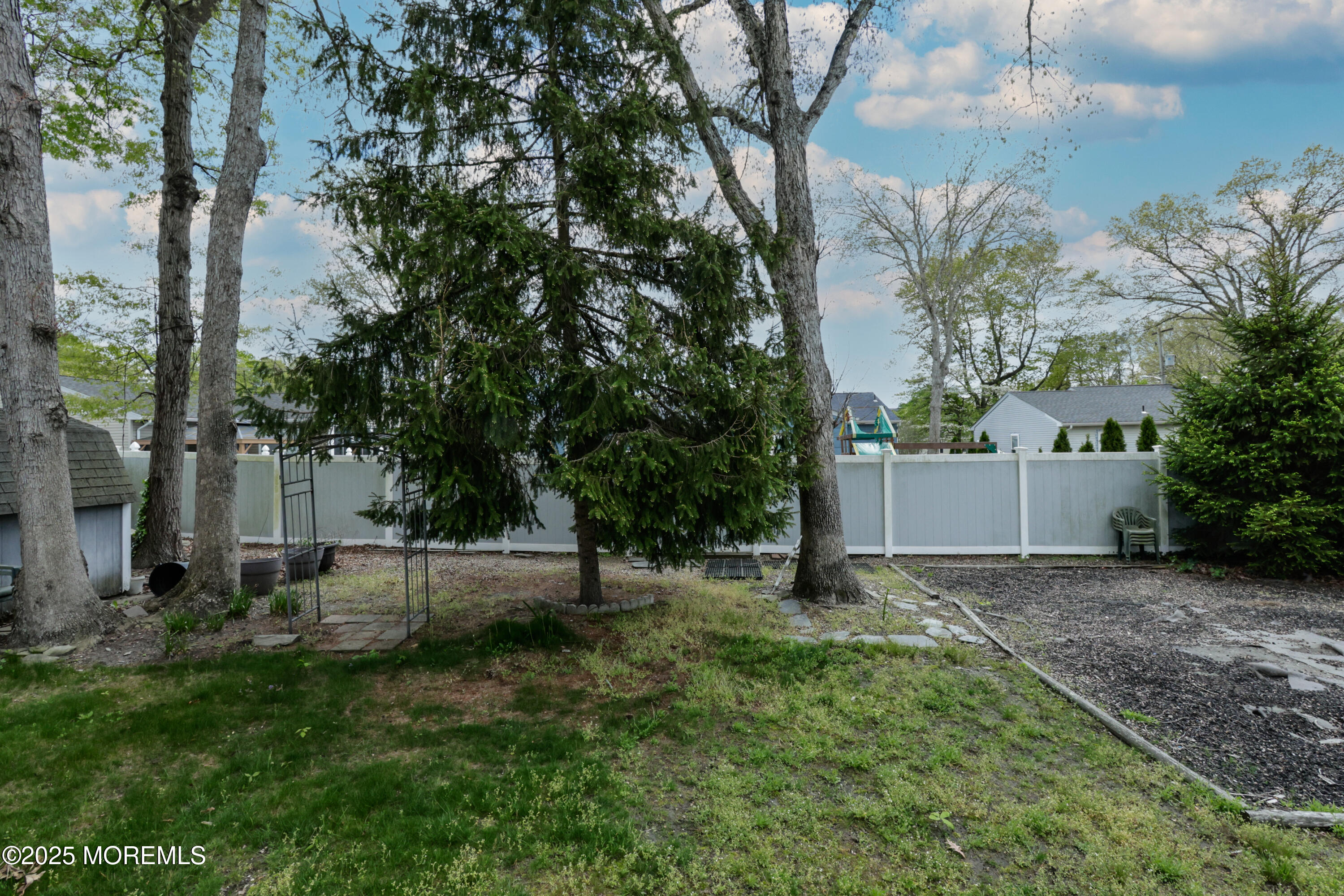 204 Stormy Road Manahawkin, NJ 08050 - Photo 43 of 44 a backyard of a house with lots of green space