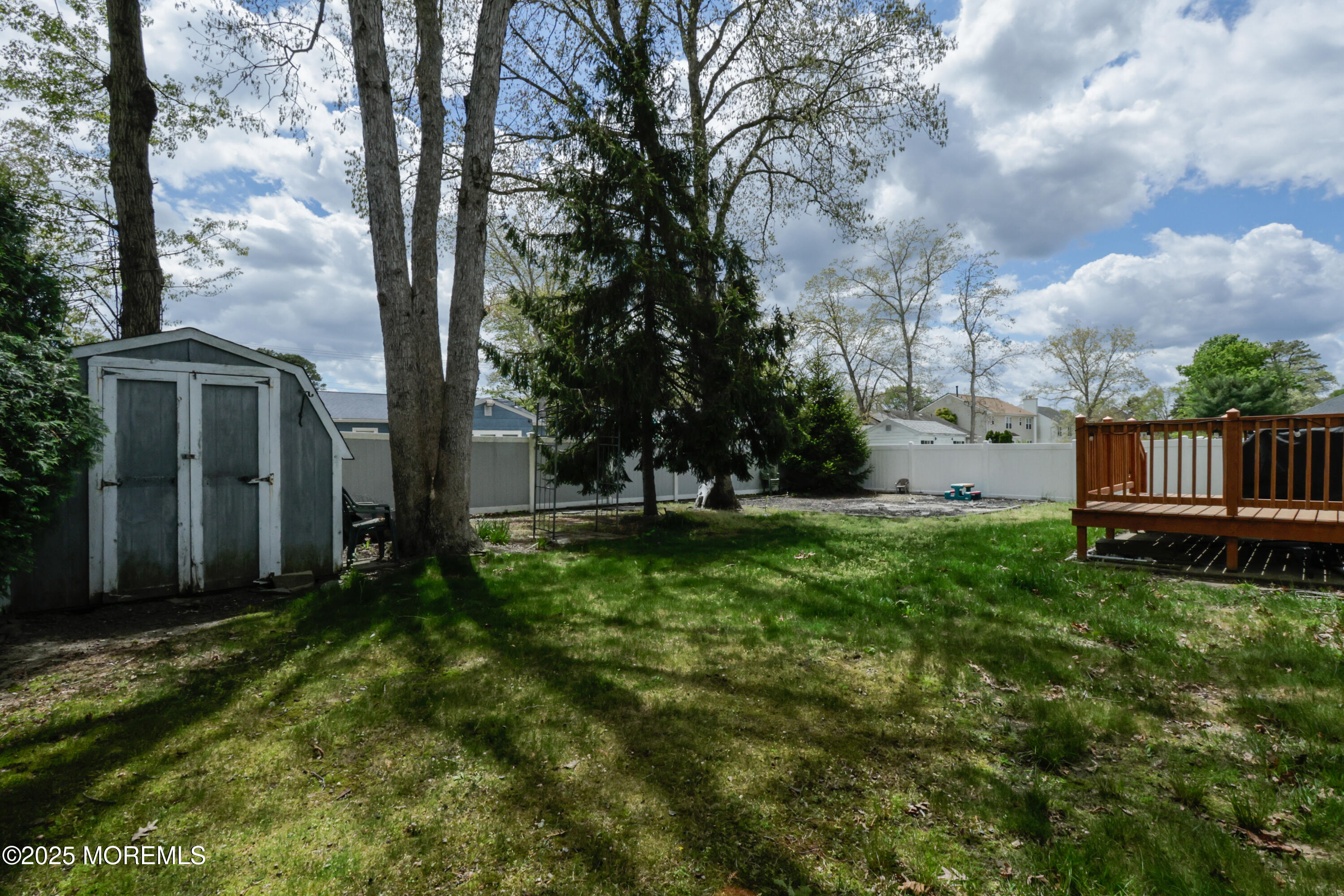 204 Stormy Road Manahawkin, NJ 08050 - Photo 44 of 44 a view of backyard with large trees and wooden fence