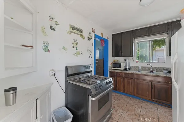 a kitchen with stainless steel appliances a stove a sink and a refrigerator