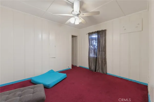 an empty room with fan and fan