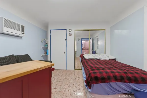 a bedroom with a bed and a dresser