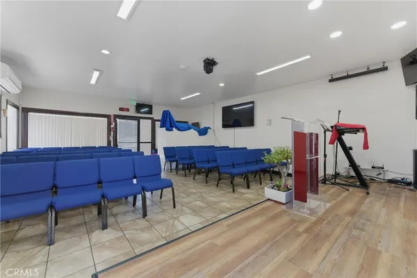 a living room with furniture a wooden floor and gym equipment