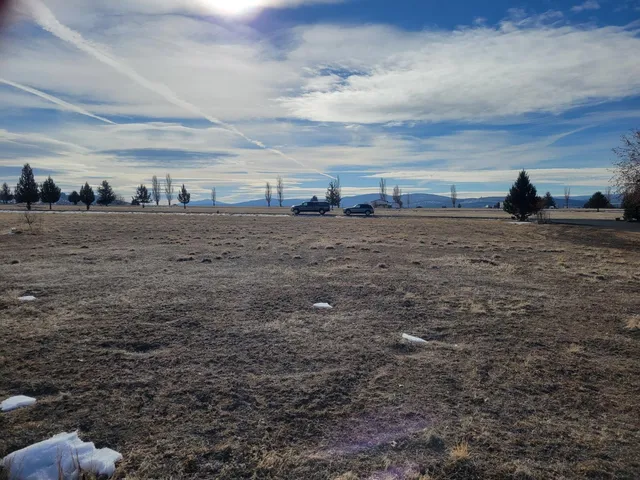 a view of car parked on road with city view