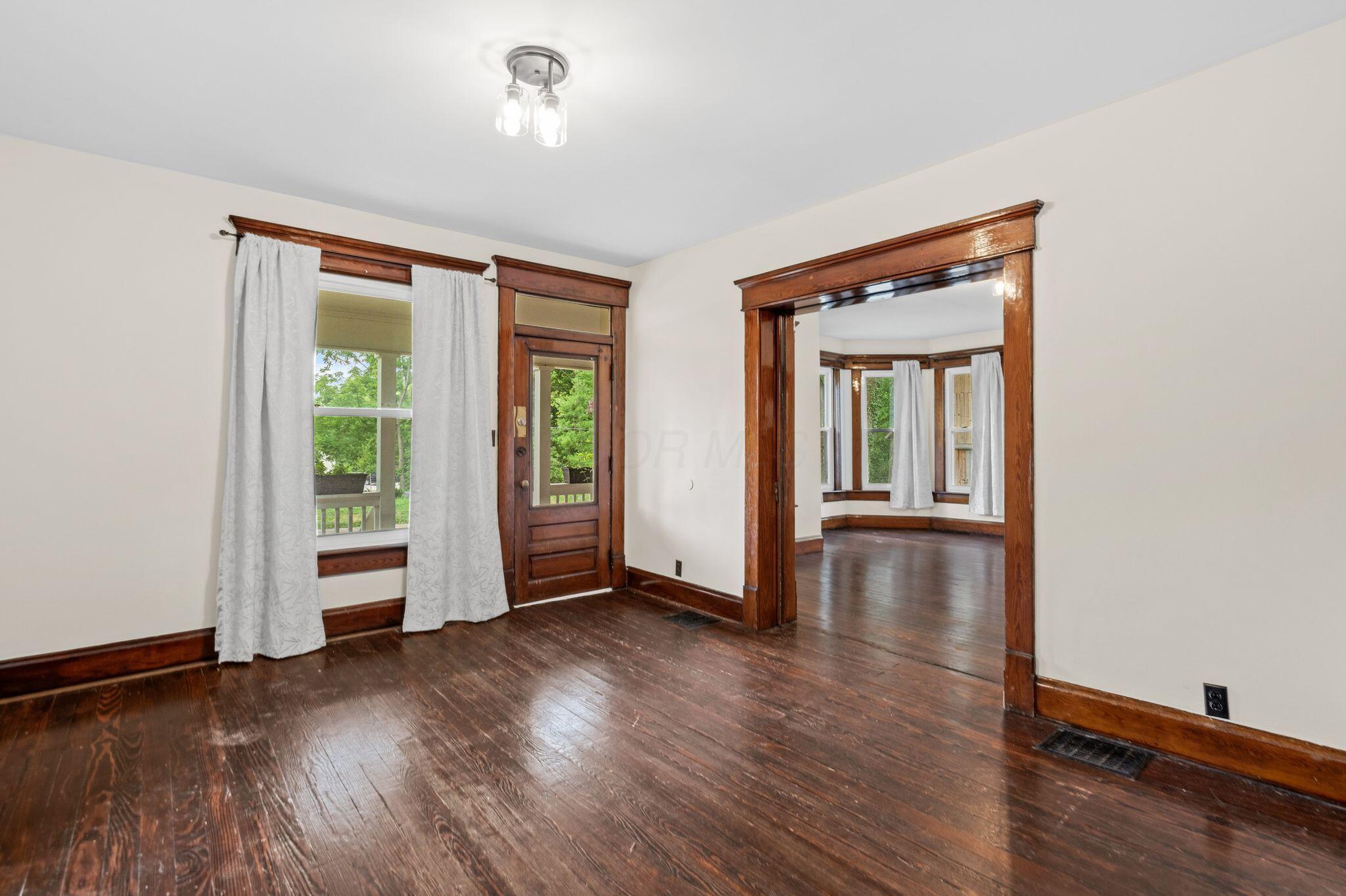 107 Price Road Columbus, OH 43230 - Photo 3 of 51 Dark wood-finish flooring with rich wood trim throughout