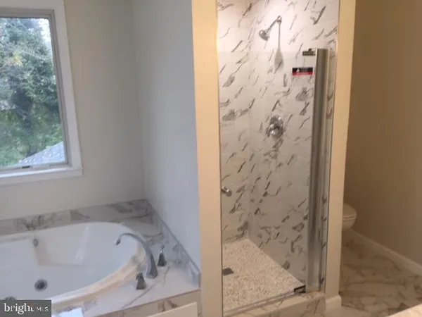 a bath tub sitting next to a shower