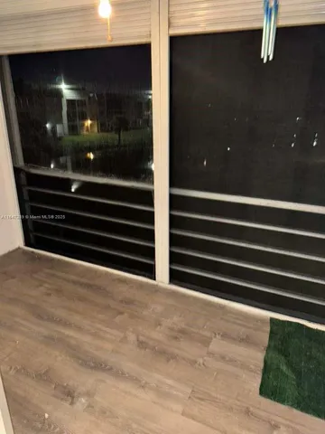 a kitchen with white cabinets and sink
