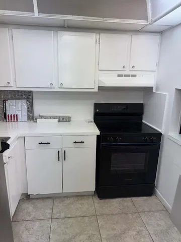 a kitchen with stainless steel appliances a stove and cabinets
