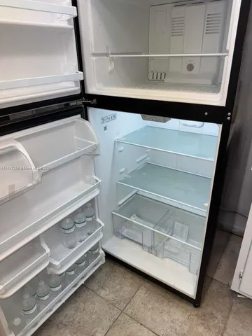 a view of an empty room with empty shelves