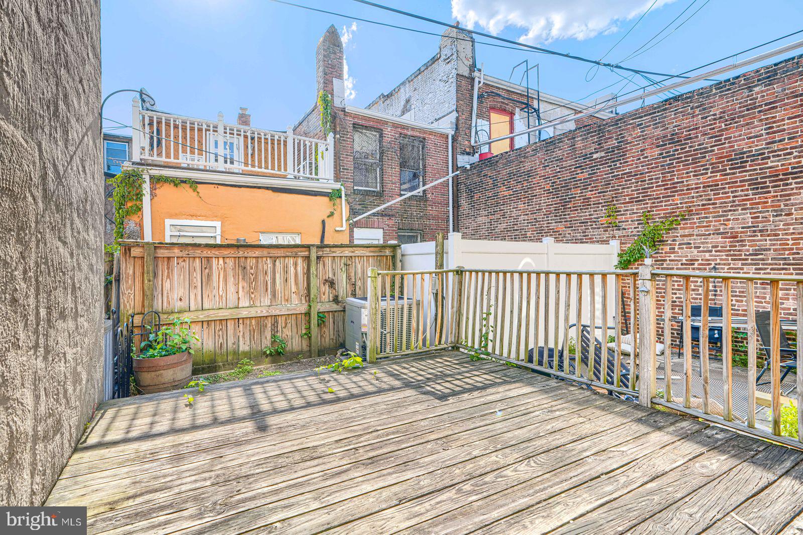 1026 Patapsco Street Baltimore, MD 21230 - Photo 9 of 24 a view of a wooden deck with a yard