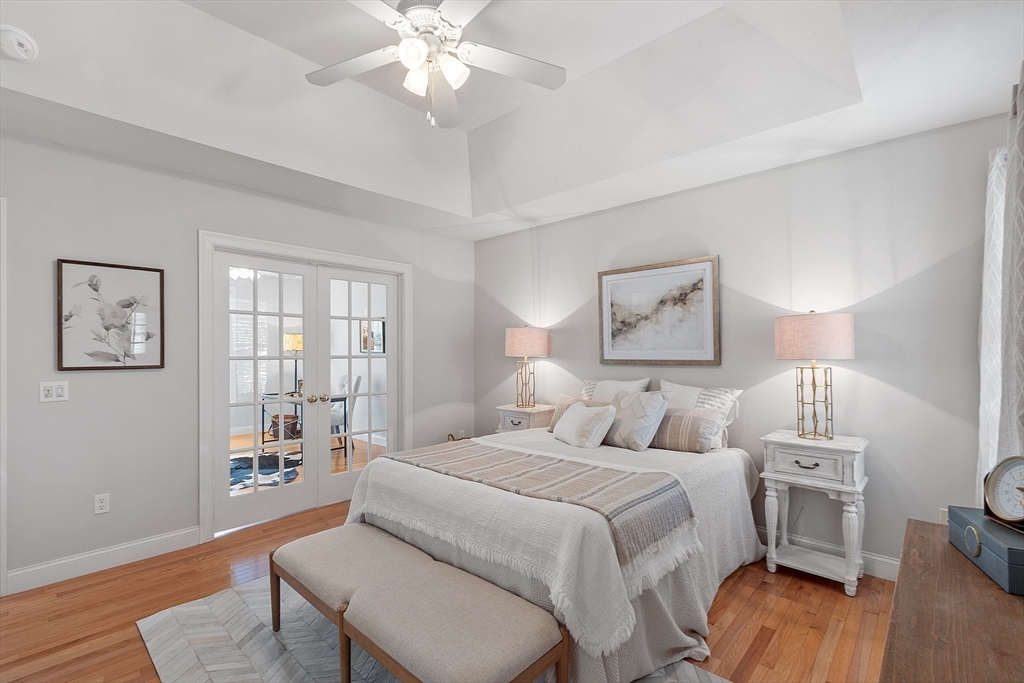 88 Ferry Road Salisbury, MA 01952 - Photo 23 of 42 a bedroom with a bed and a chandelier