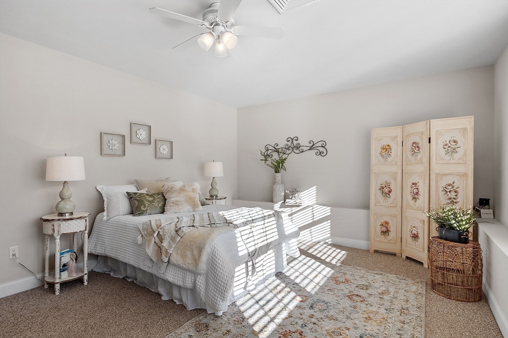 88 Ferry Road Salisbury, MA 01952 - Photo 33 of 42 a bedroom with a bed and a chandelier