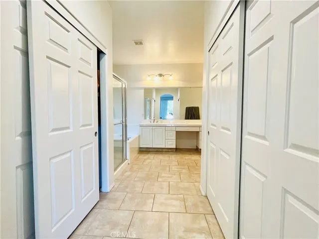 a bathroom with a glass shower door and a mirror