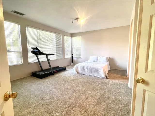 a bedroom with a bed a table and chair