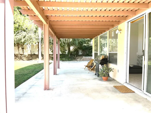 a view of a porch with chairs and backyard
