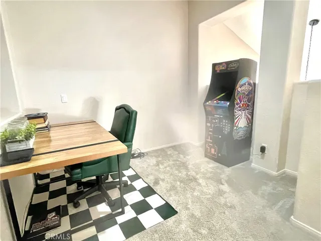 a living room with a black white checkered floor with couches chair and a coffee table