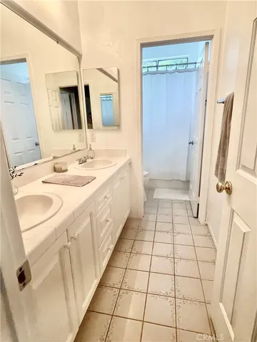 a bathroom with a sink a mirror and a shower