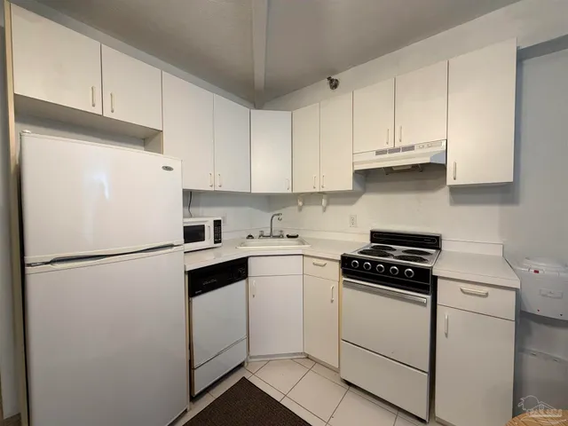 a white refrigerator freezer sitting in a kitchen
