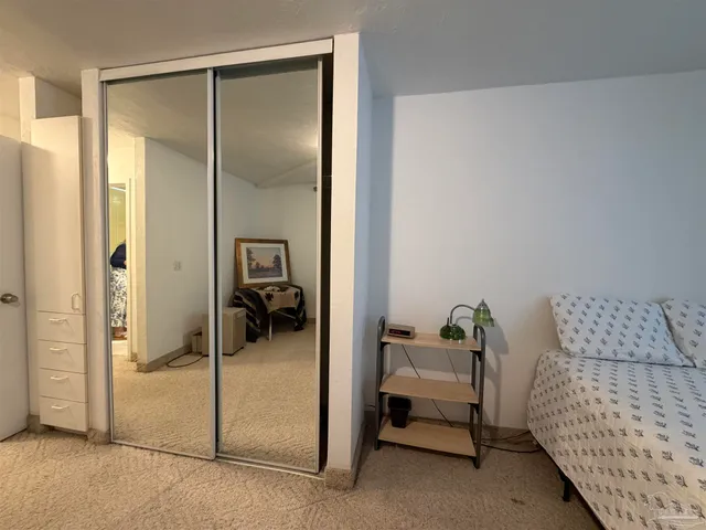 a bedroom with a bed and lamp