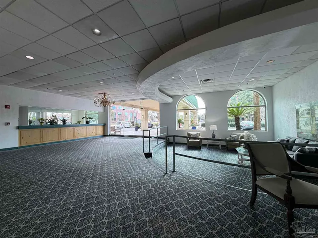 a room with lots of furniture and a large window