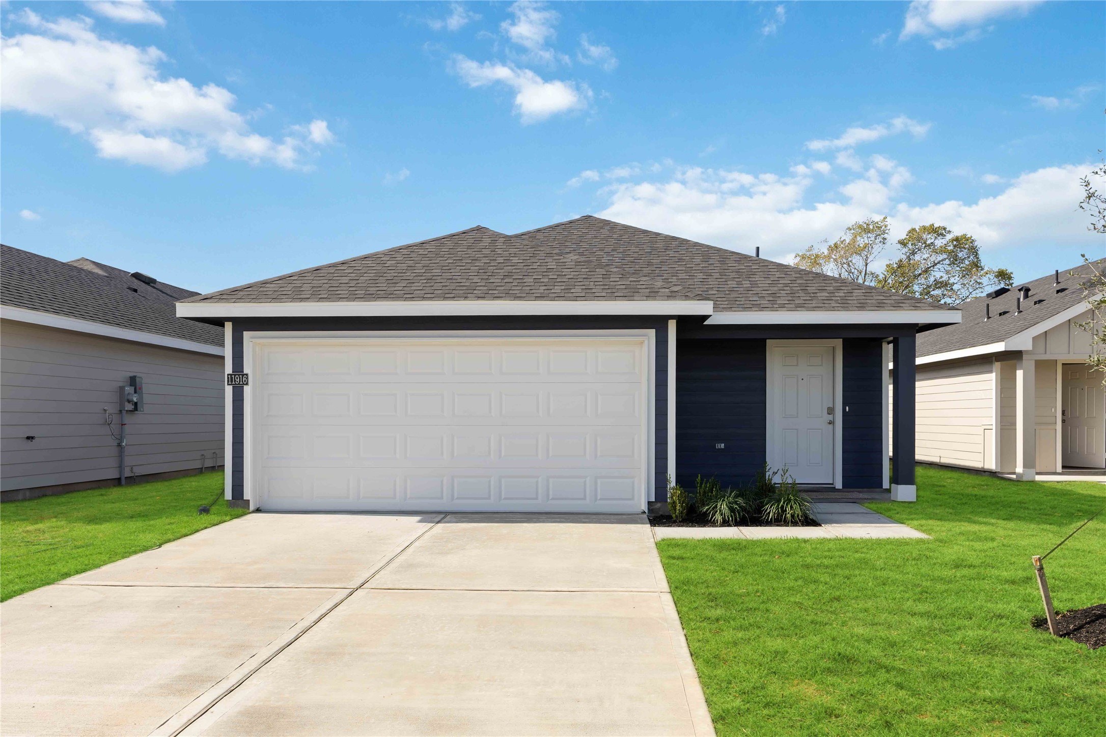 a front view of house with yard and garage